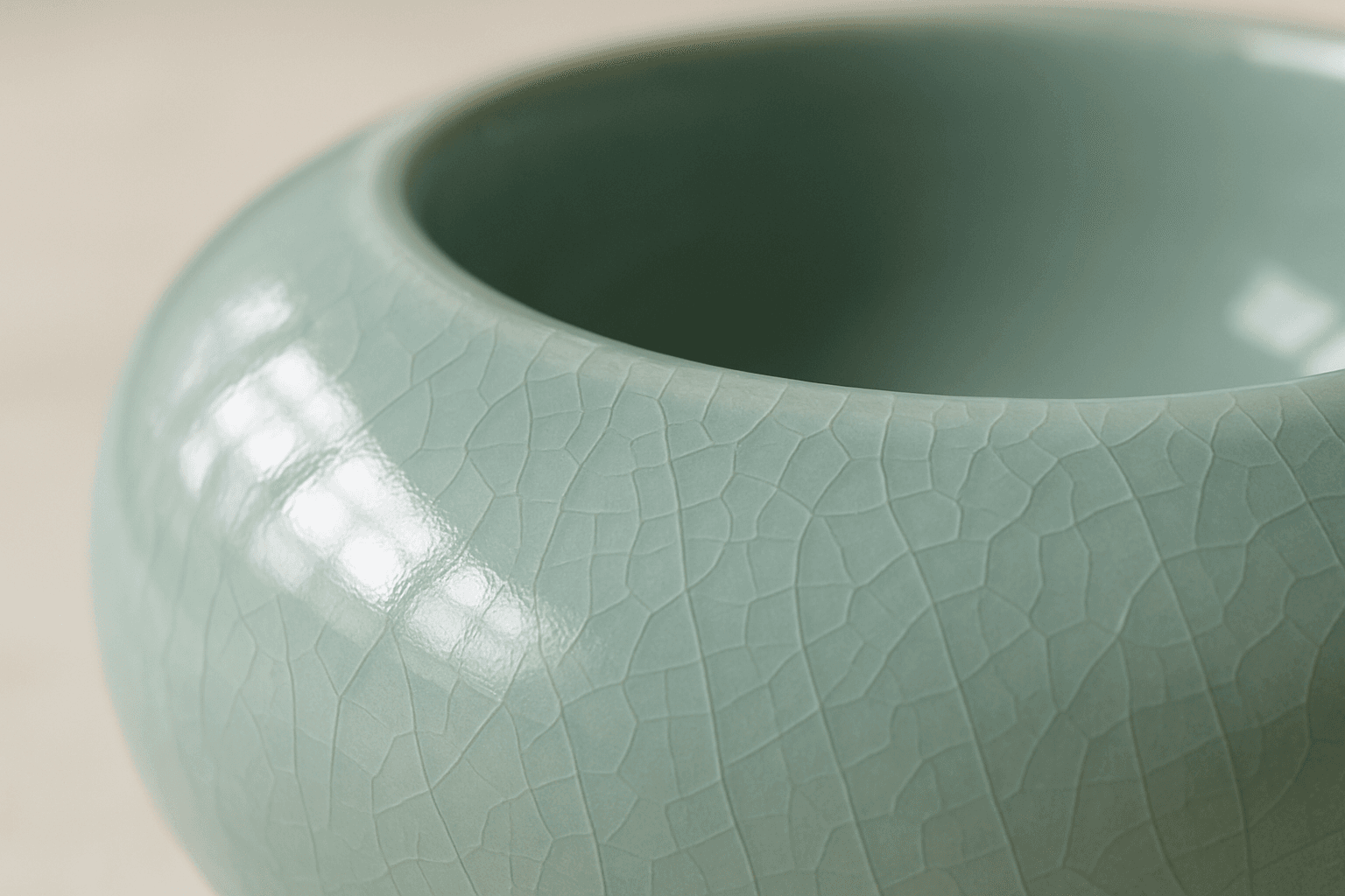 Close-up of a smooth glossy ceramic surface with delicate glaze reflections under soft natural light