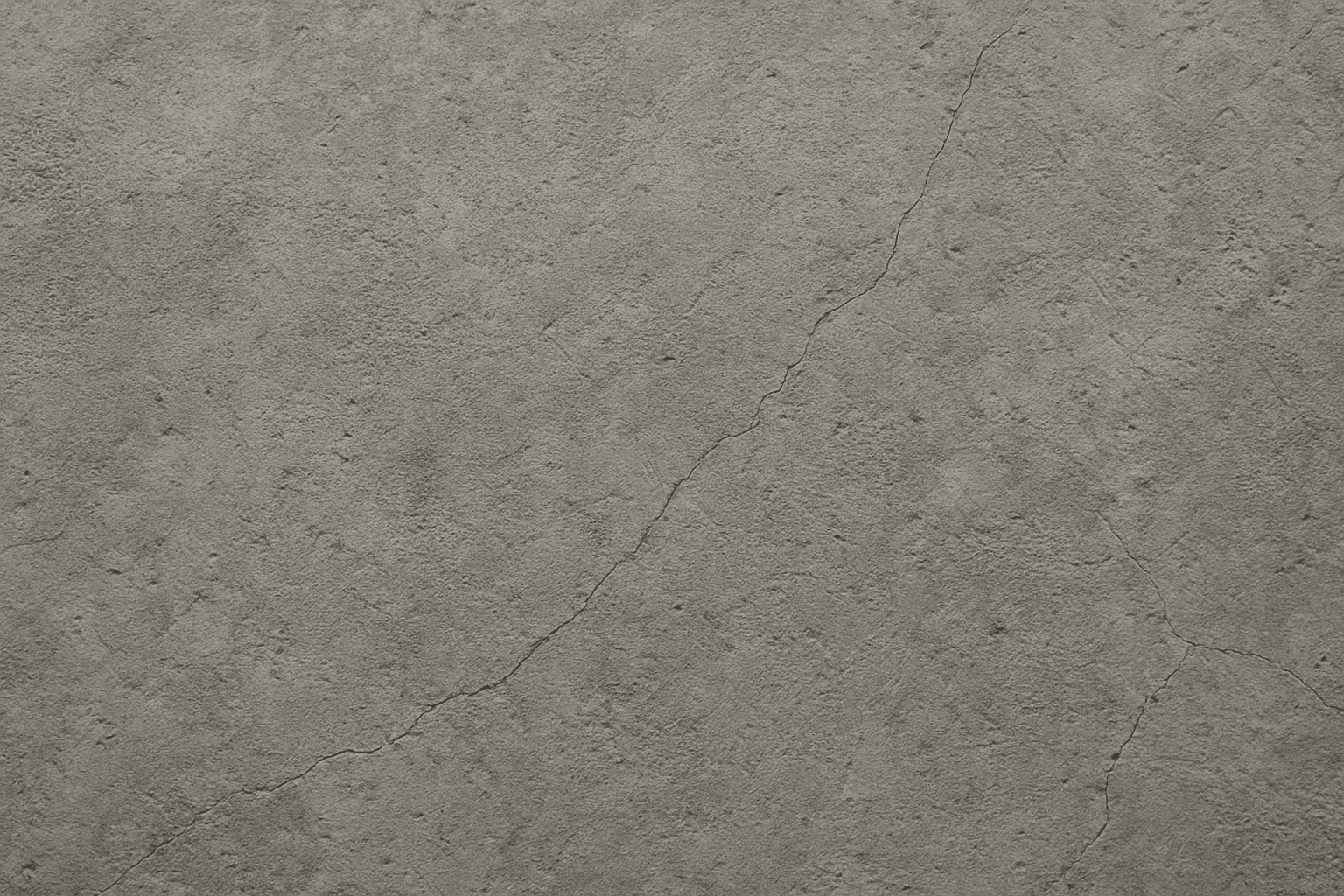 Close-up of rough concrete floor texture with cracks and pits