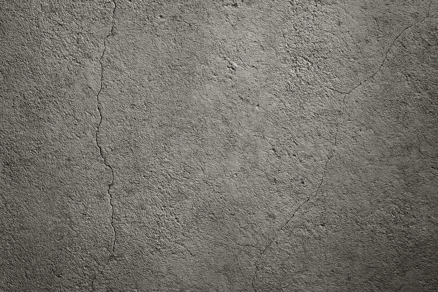 Close-up detailed texture of a rough gray concrete wall with subtle cracks and stains