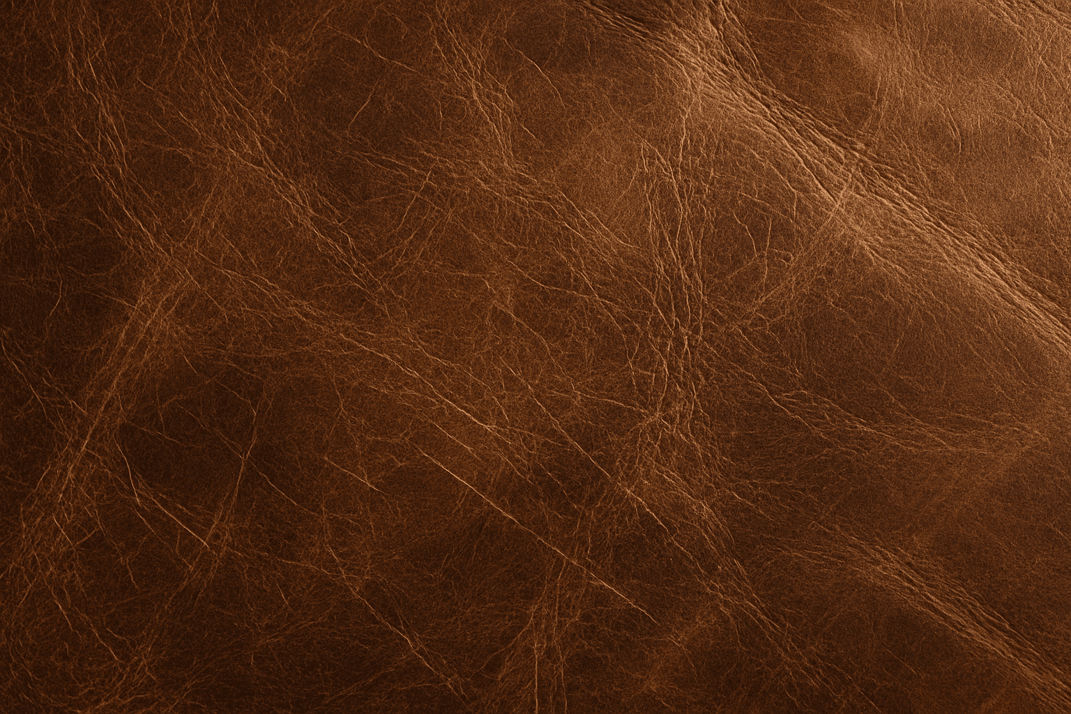Close-up of distressed brown leather material showing scratches and creases