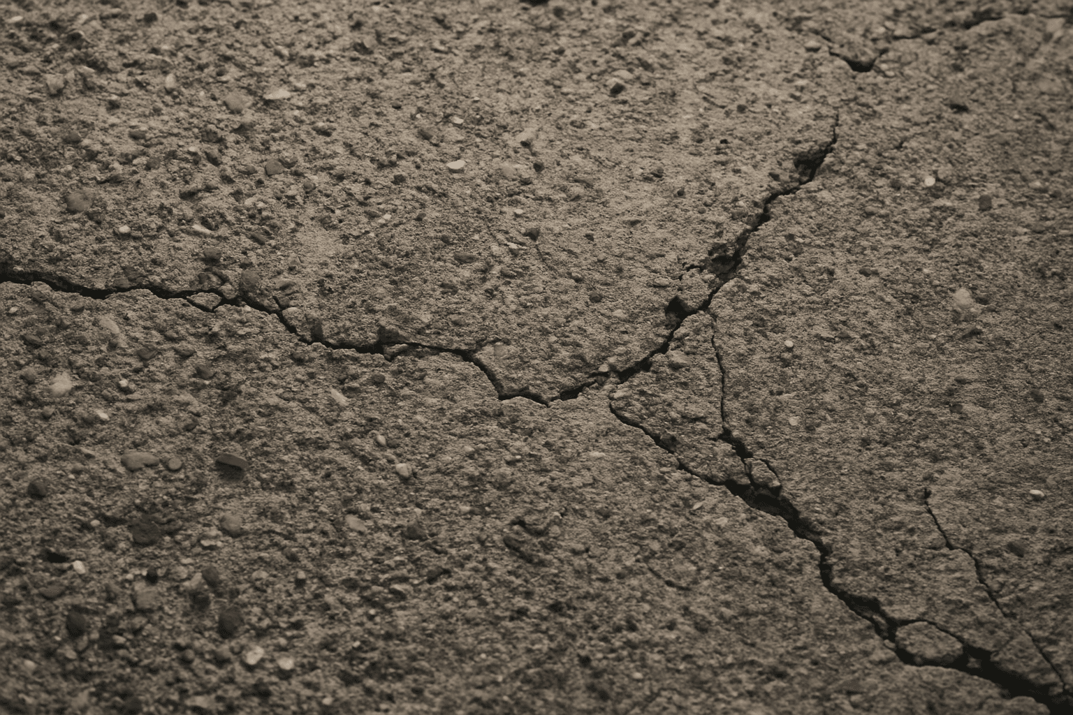 Close-up textured industrial concrete surface showing roughness and natural wear