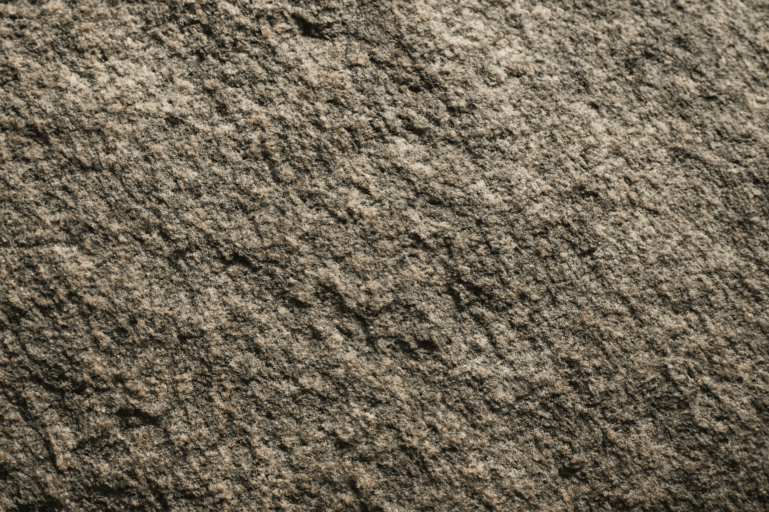 Close-up detailed rough stone surface texture showing coarse grain and natural cracks