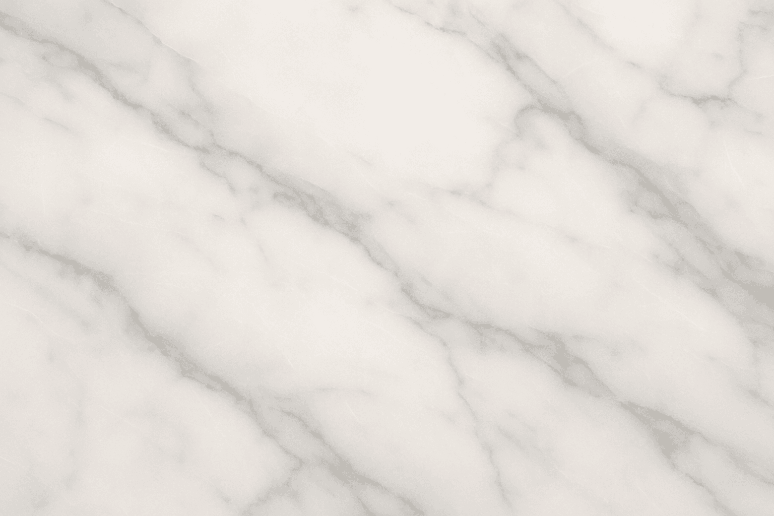 Close-up of a polished smooth marble surface with subtle grey veining and a glossy finish