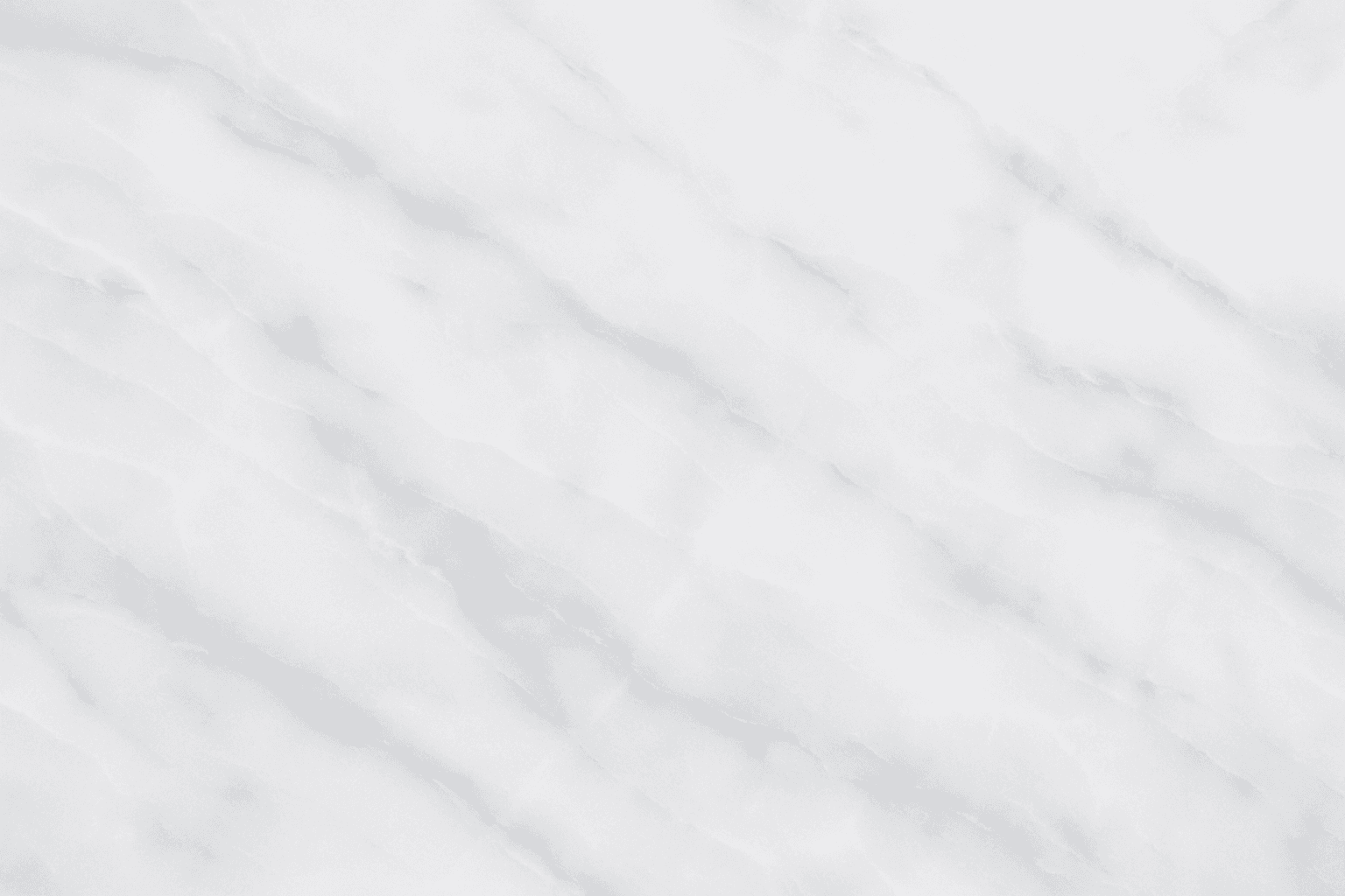 Close-up of smooth marble texture with subtle natural veining on polished white stone surface